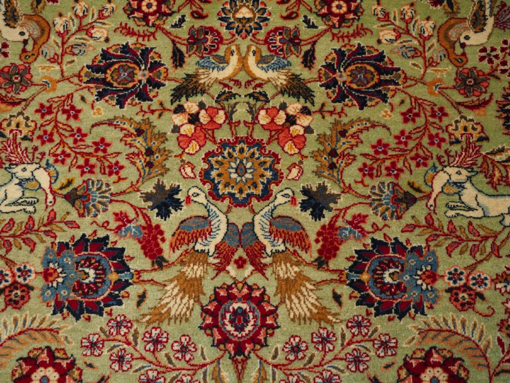 OLD TABRIZ RUG WITH HUNTING DESIGN ON A GREEN GROUND, CIRCA 1930. View IX