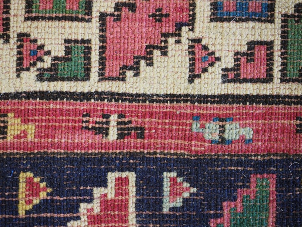 An antique hand-knotted Anatolian Kirsehir prayer rug featuring a central red arch motif framed by green sections and geometric borders. View XI