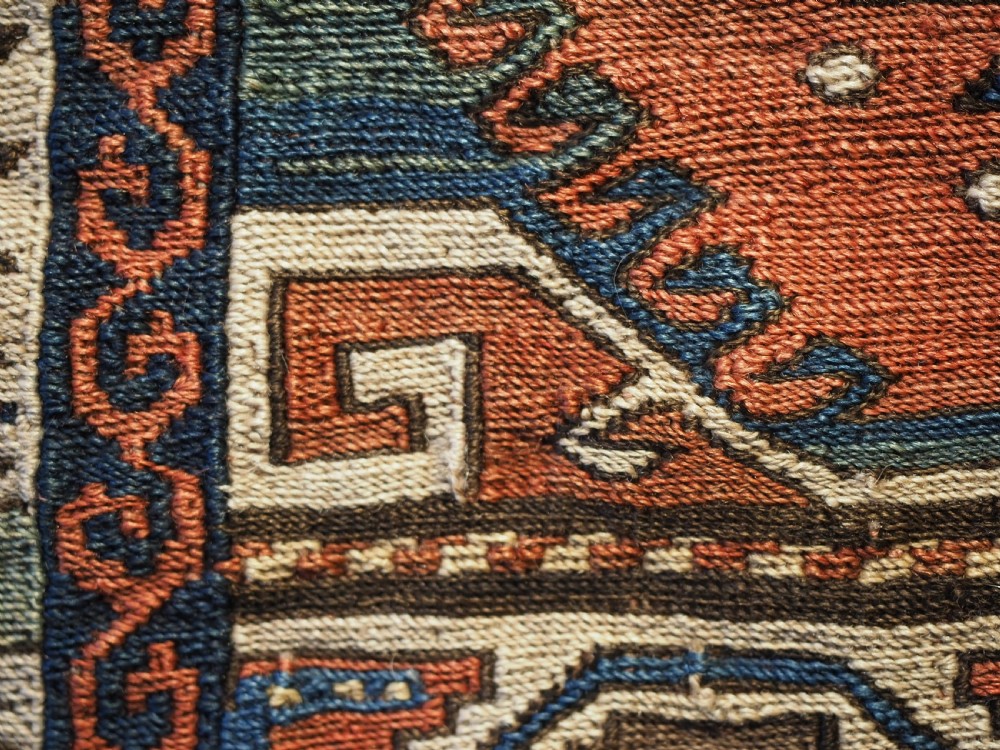 An antique flatwoven wool Shahsavan khorjin bag face featuring geometric octagonal medallions and running dog borders in terracotta red, indigo blue, cream, and sage green. View IX