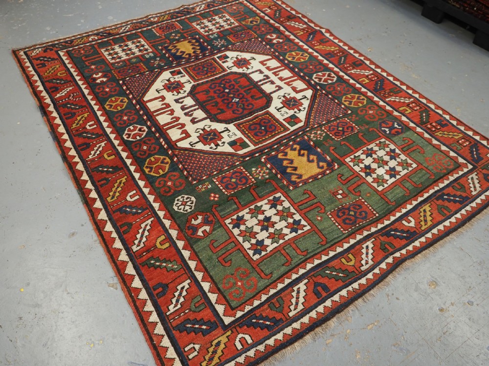 ANTIQUE CAUCASIAN KARACHOV KAZAK RUG WITH GREEN GROUND, CIRCA 1890. View II