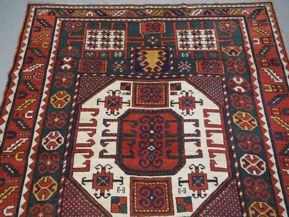 ANTIQUE CAUCASIAN KARACHOV KAZAK RUG WITH GREEN GROUND, CIRCA 1890. View III
