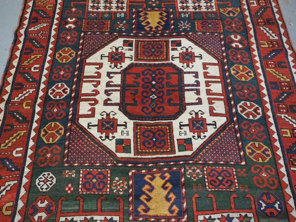 ANTIQUE CAUCASIAN KARACHOV KAZAK RUG WITH GREEN GROUND, CIRCA 1890. View IV