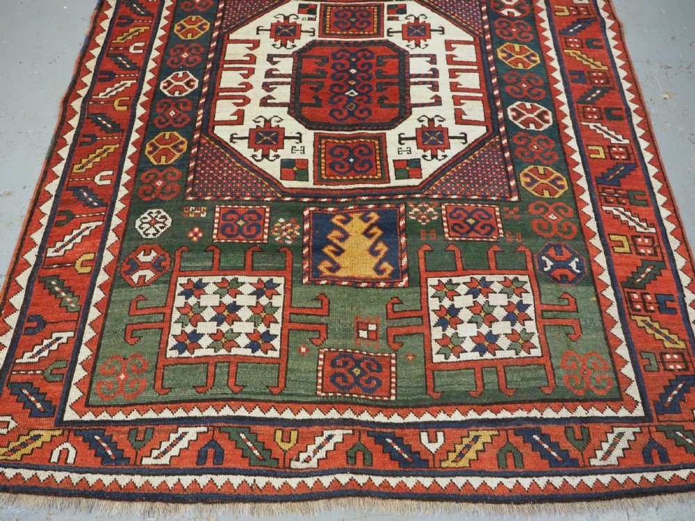 ANTIQUE CAUCASIAN KARACHOV KAZAK RUG WITH GREEN GROUND, CIRCA 1890. View V
