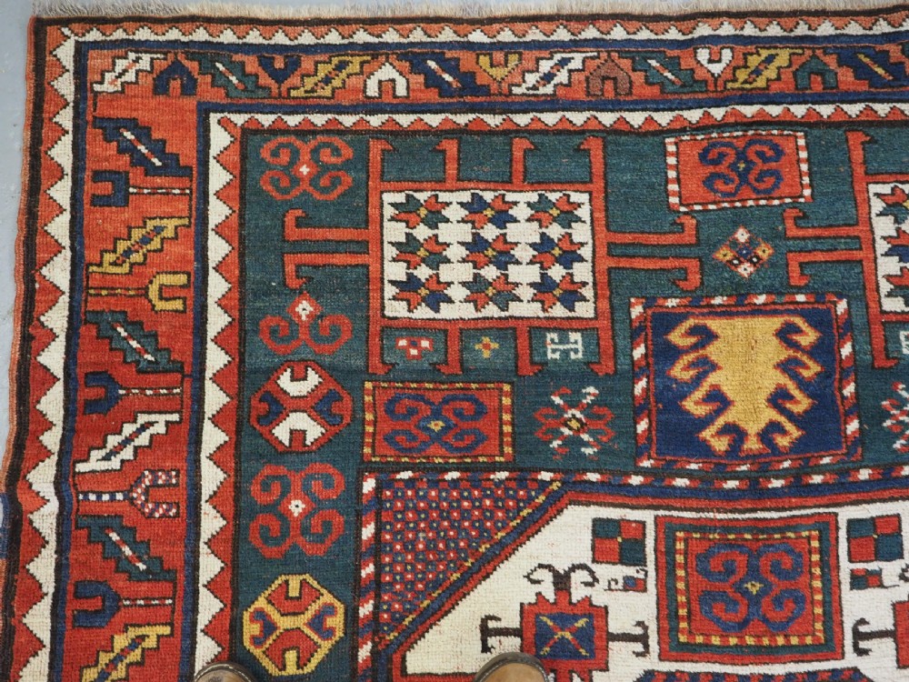 ANTIQUE CAUCASIAN KARACHOV KAZAK RUG WITH GREEN GROUND, CIRCA 1890. View VI