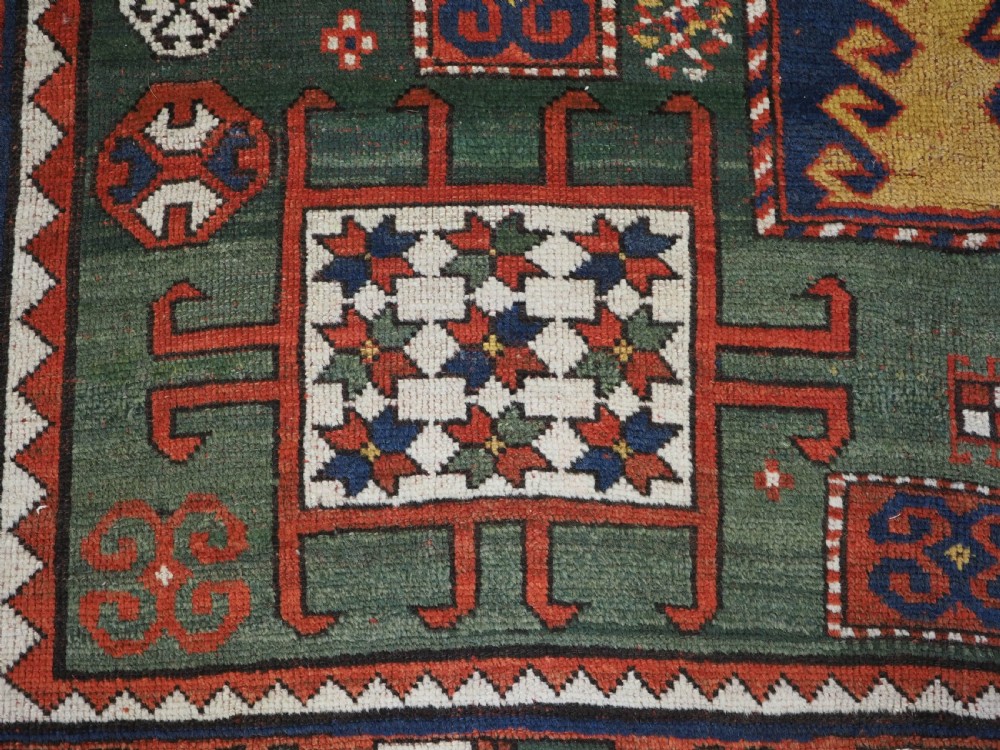 ANTIQUE CAUCASIAN KARACHOV KAZAK RUG WITH GREEN GROUND, CIRCA 1890. View VII