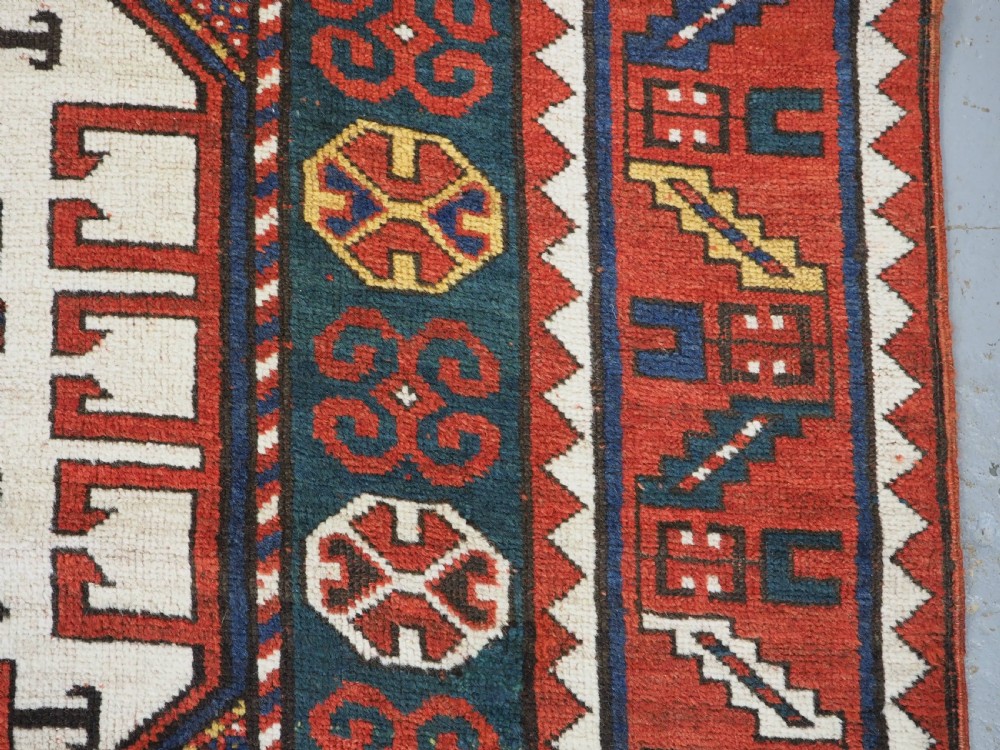 ANTIQUE CAUCASIAN KARACHOV KAZAK RUG WITH GREEN GROUND, CIRCA 1890. View VIII