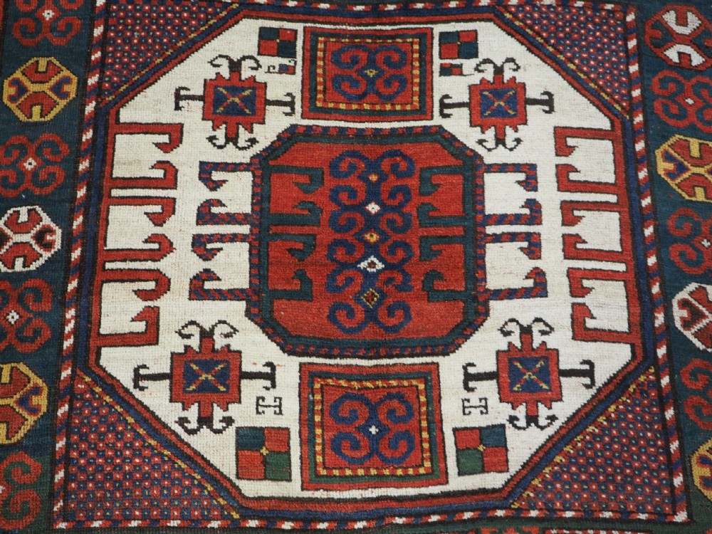 ANTIQUE CAUCASIAN KARACHOV KAZAK RUG WITH GREEN GROUND, CIRCA 1890. View X