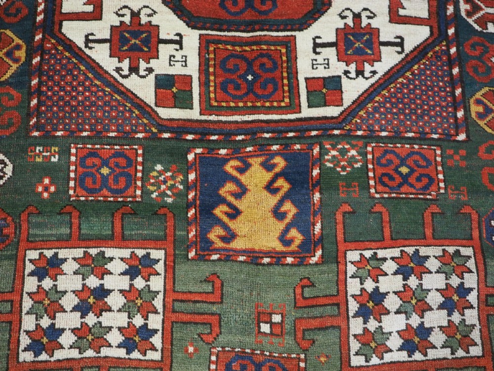 ANTIQUE CAUCASIAN KARACHOV KAZAK RUG WITH GREEN GROUND, CIRCA 1890. View XII