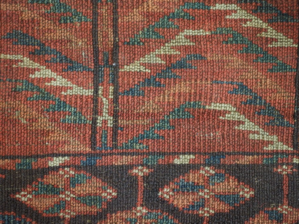 A hand-knotted wool Tekke Turkmen Ensi rug featuring a terracotta red field divided into four panels with dark geometric motifs and intricate borders. View XV