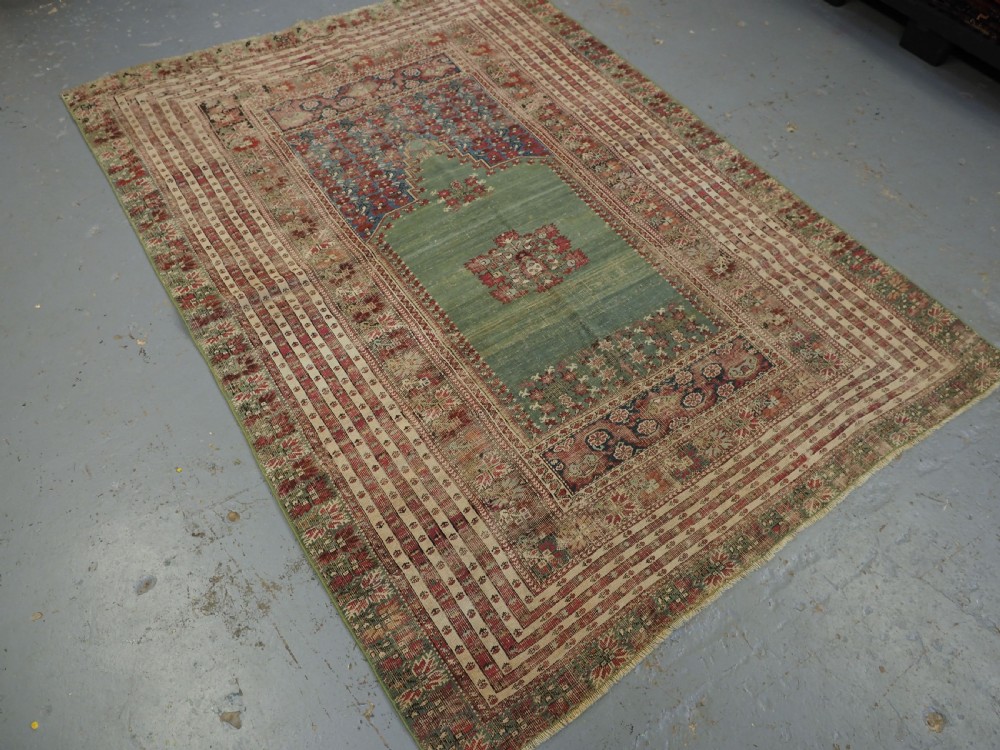 ANTIQUE TURKISH GHIORDES PRAYER RUG, MULTIPLE BORDERS, GREEN FIELD, CIRCA 1750. View II