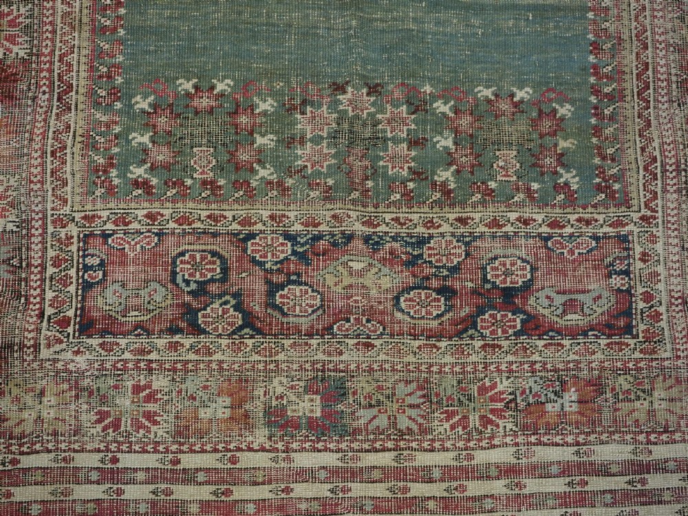 ANTIQUE TURKISH GHIORDES PRAYER RUG, MULTIPLE BORDERS, GREEN FIELD, CIRCA 1750. View X