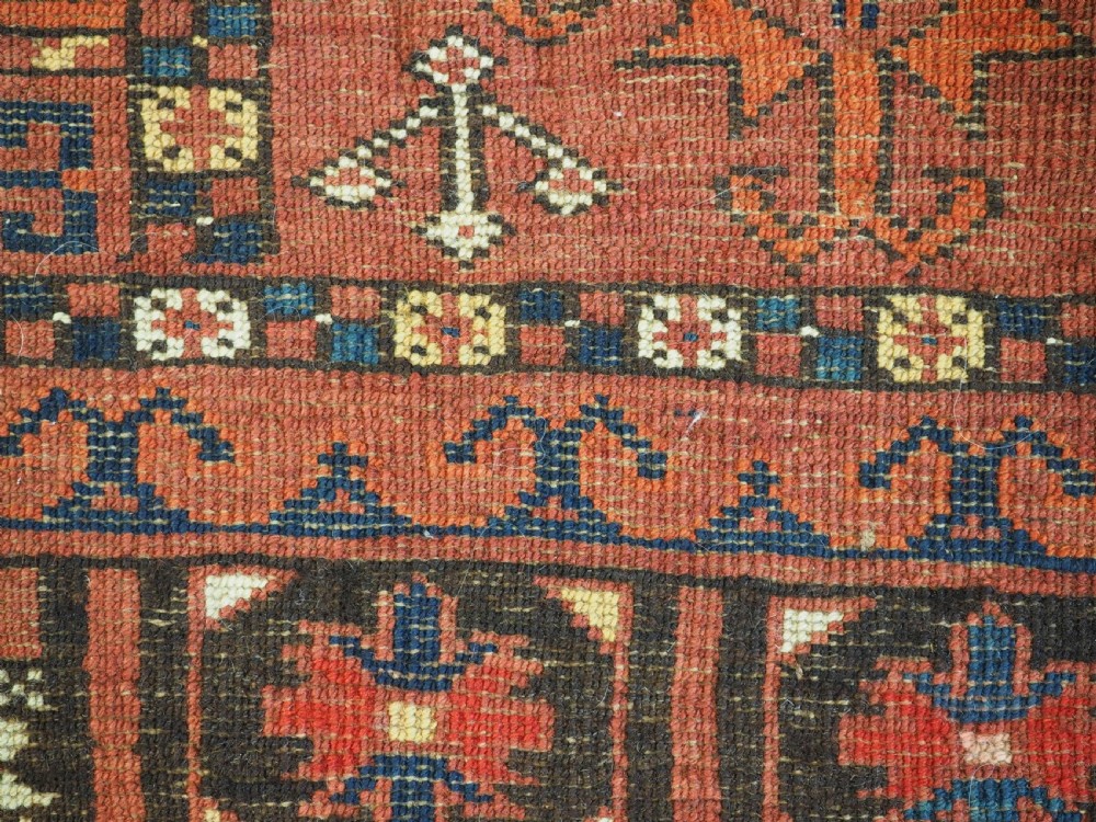 An antique hand-knotted Ersari Turkmen Ensi wool rug featuring deep red tones, a central cruciform design, geometric borders, and a woven fringe. View XIII