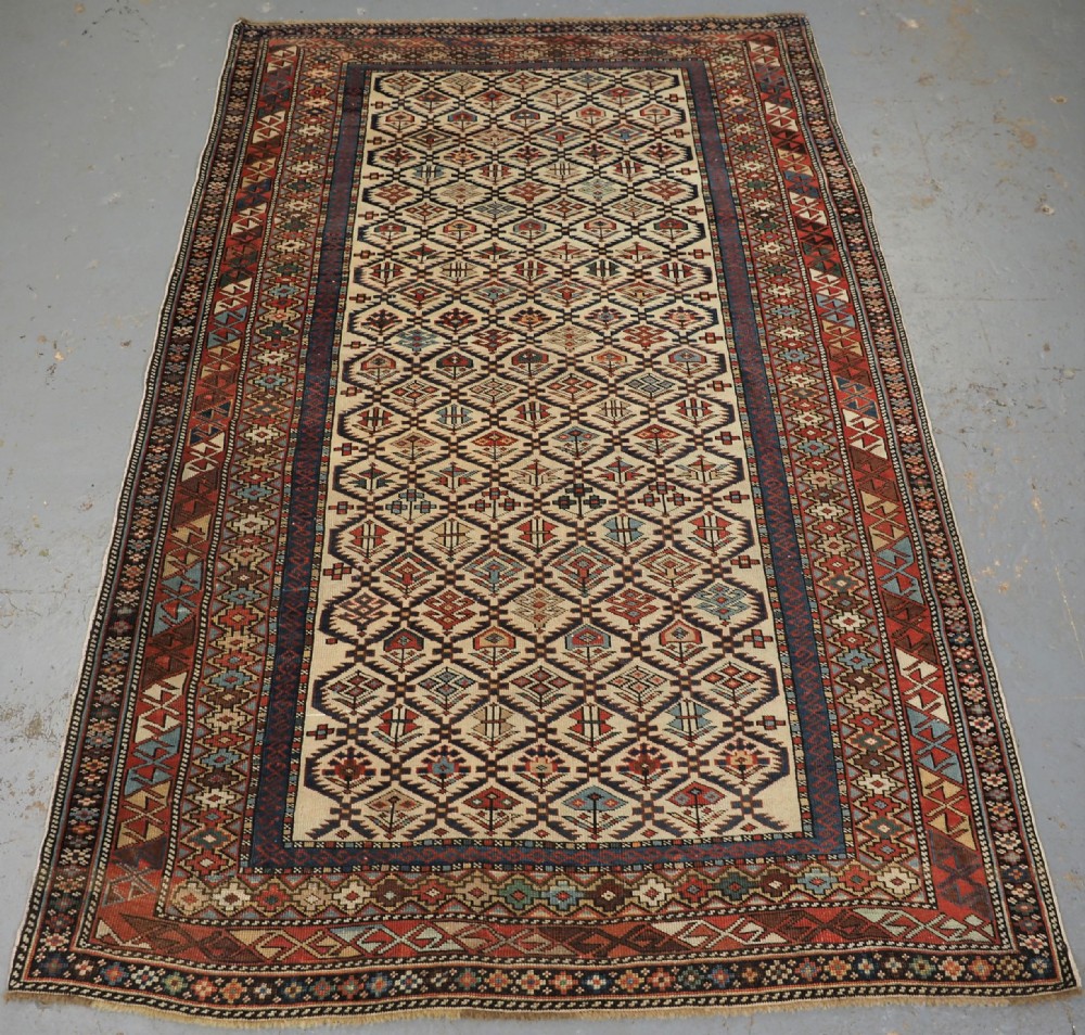 ANTIQUE CAUCASIAN DAGESTAN RUG WITH IVORY GROUND FLORAL LATTICE, SUPERB, CIRCA 1880.