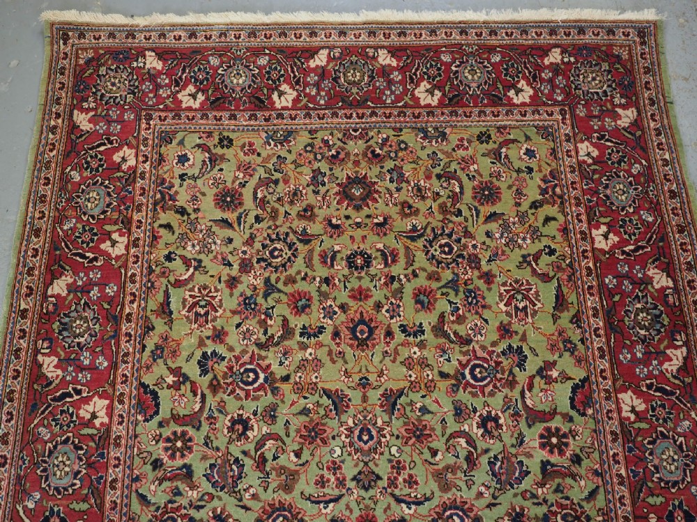 ANTIQUE KASHAN RUG WITH FINE FLORAL DESIGN ON A SCARCE GREEN GROUND, CIRCA 1900. View III