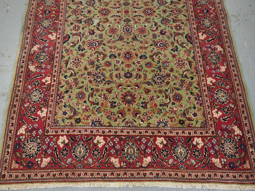 ANTIQUE KASHAN RUG WITH FINE FLORAL DESIGN ON A SCARCE GREEN GROUND, CIRCA 1900. View IV
