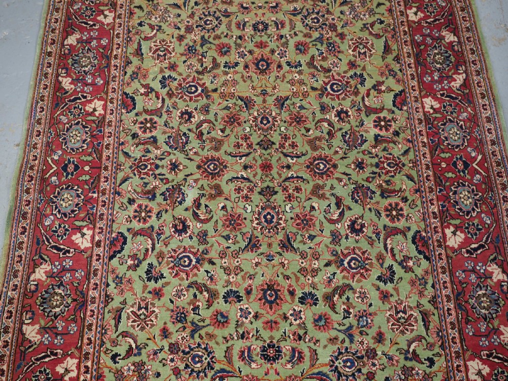 ANTIQUE KASHAN RUG WITH FINE FLORAL DESIGN ON A SCARCE GREEN GROUND, CIRCA 1900. View V