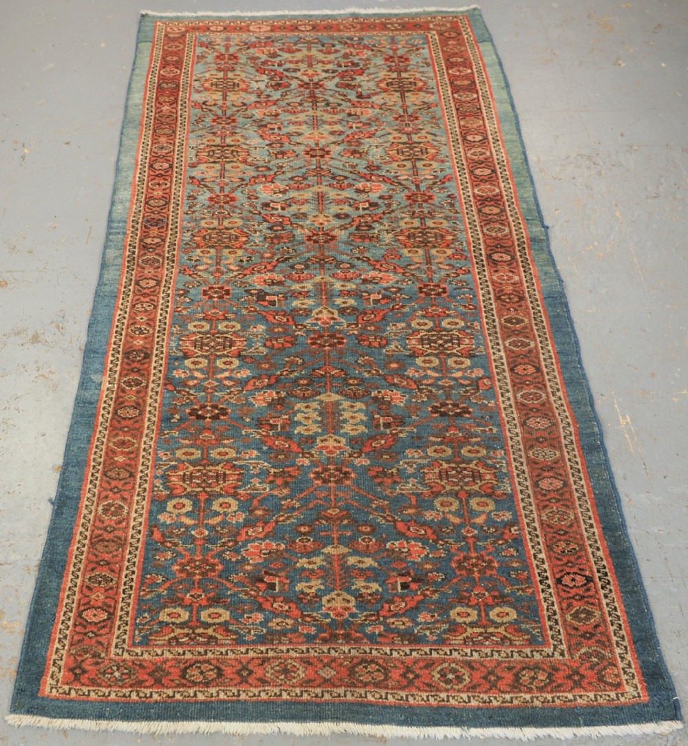 ANTIQUE ZIEGLER RUG WITH SHRUB DESIGN, POWDER BLUE GROUND, CIRCA 1890.
