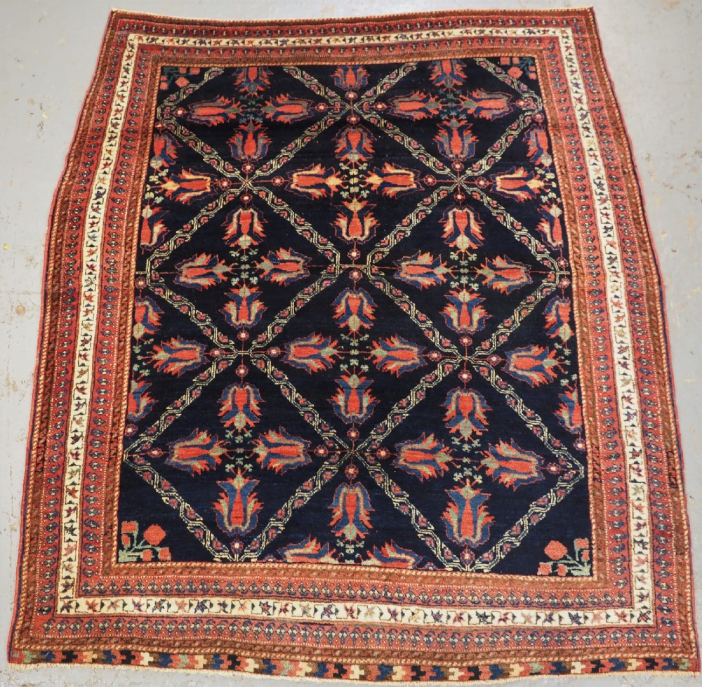 ANTIQUE AFSHAR TRIBAL RUG WITH LATTICE AND TULIP DESIGN, CIRCA 1890.