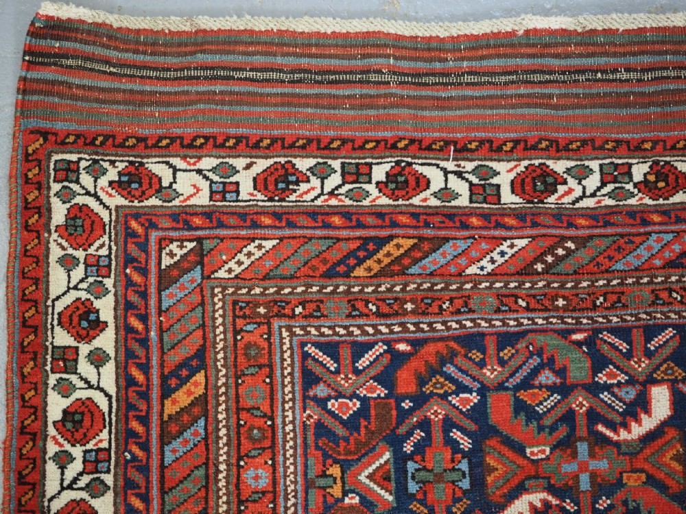 An antique hand-knotted wool Afshar rug featuring an all-over geometric Herati design on a dark navy blue field with a patterned cream border. View VI