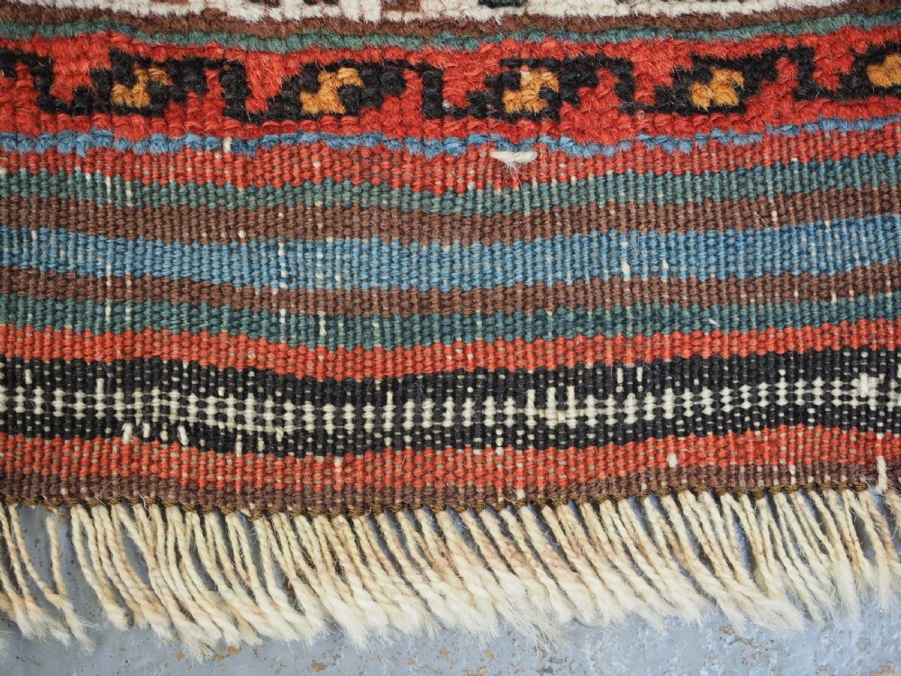 An antique hand-knotted wool Afshar rug featuring an all-over geometric Herati design on a dark navy blue field with a patterned cream border. View VIII