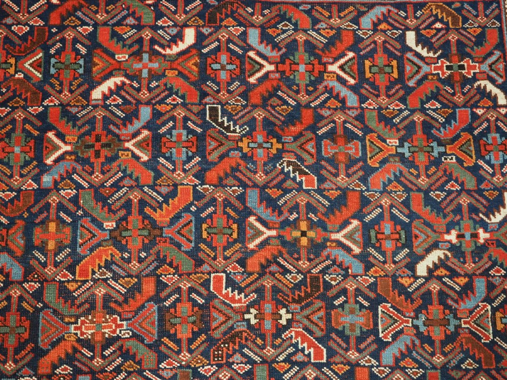 An antique hand-knotted wool Afshar rug featuring an all-over geometric Herati design on a dark navy blue field with a patterned cream border. View IX