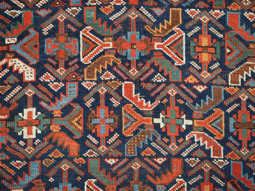 An antique hand-knotted wool Afshar rug featuring an all-over geometric Herati design on a dark navy blue field with a patterned cream border. View X