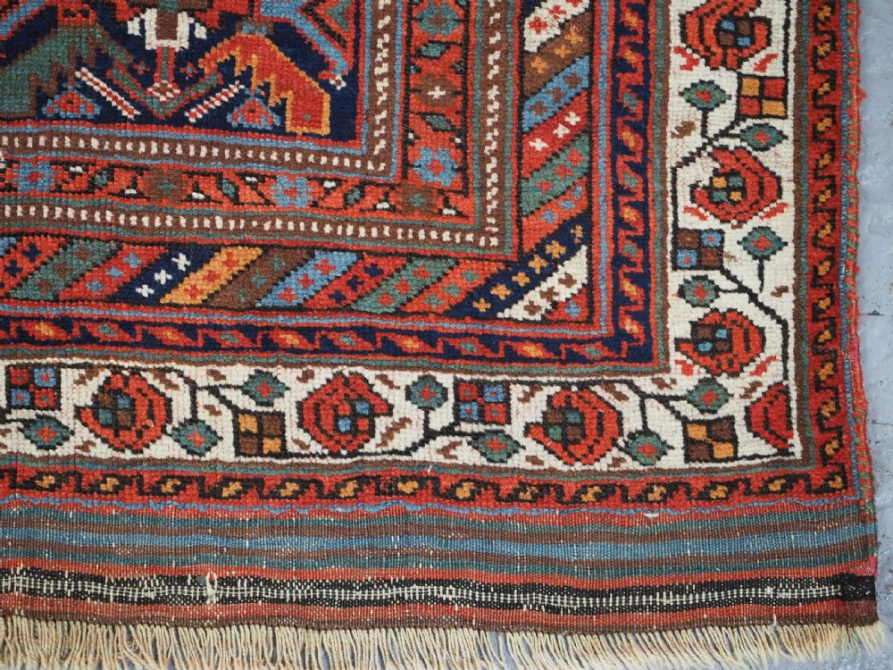 An antique hand-knotted wool Afshar rug featuring an all-over geometric Herati design on a dark navy blue field with a patterned cream border. View XII