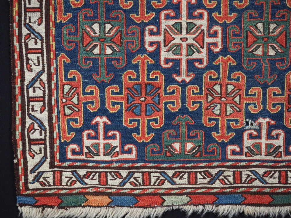 An antique square Shahsavan wool bag face featuring geometric tribal motifs woven in Soumak flatweave technique with red, blue, green, and cream hues. View IV