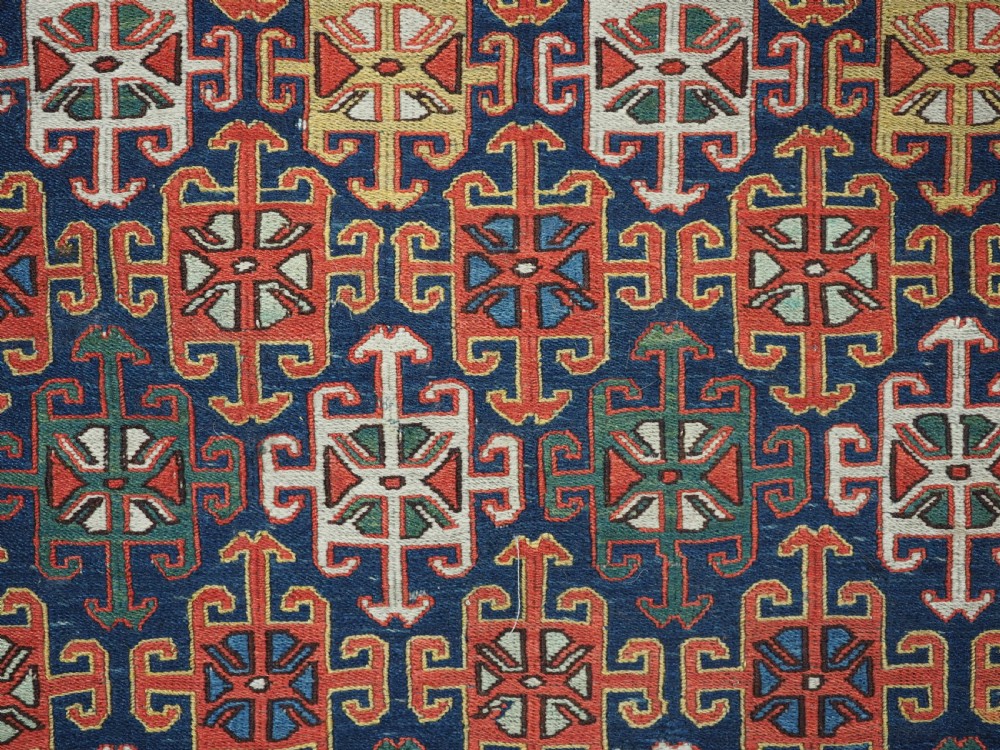 An antique square Shahsavan wool bag face featuring geometric tribal motifs woven in Soumak flatweave technique with red, blue, green, and cream hues. View VI