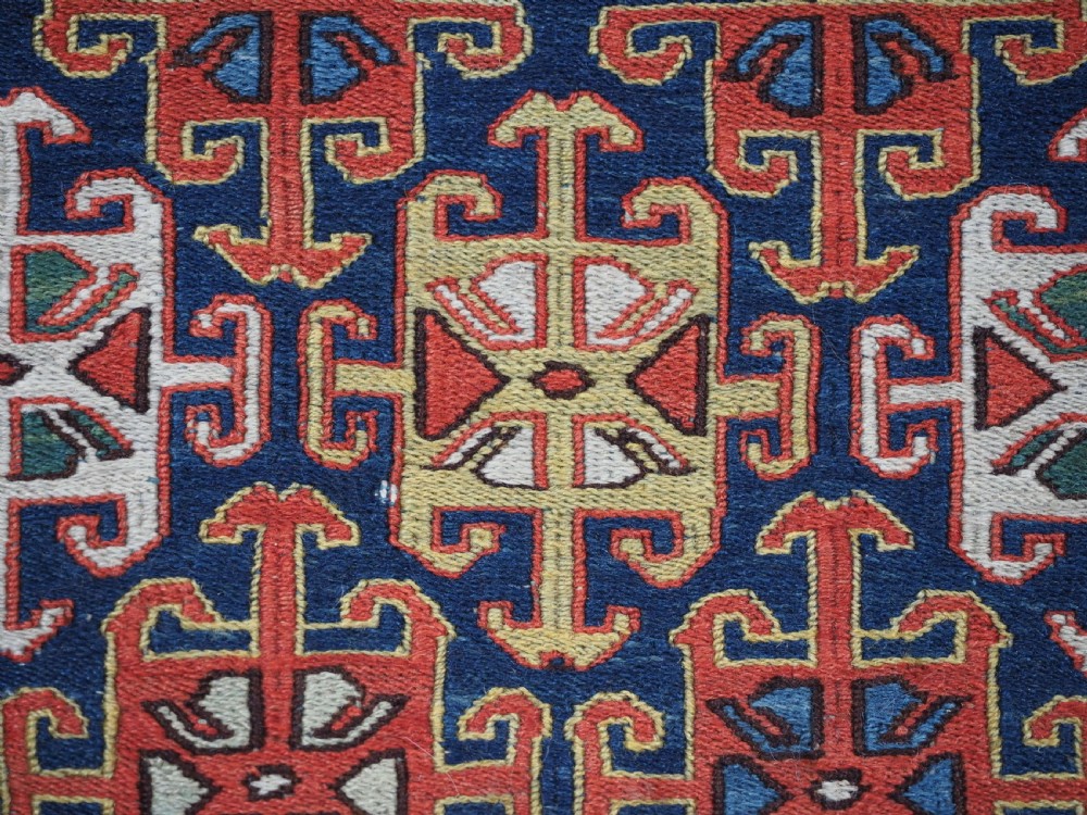 An antique square Shahsavan wool bag face featuring geometric tribal motifs woven in Soumak flatweave technique with red, blue, green, and cream hues. View VIII