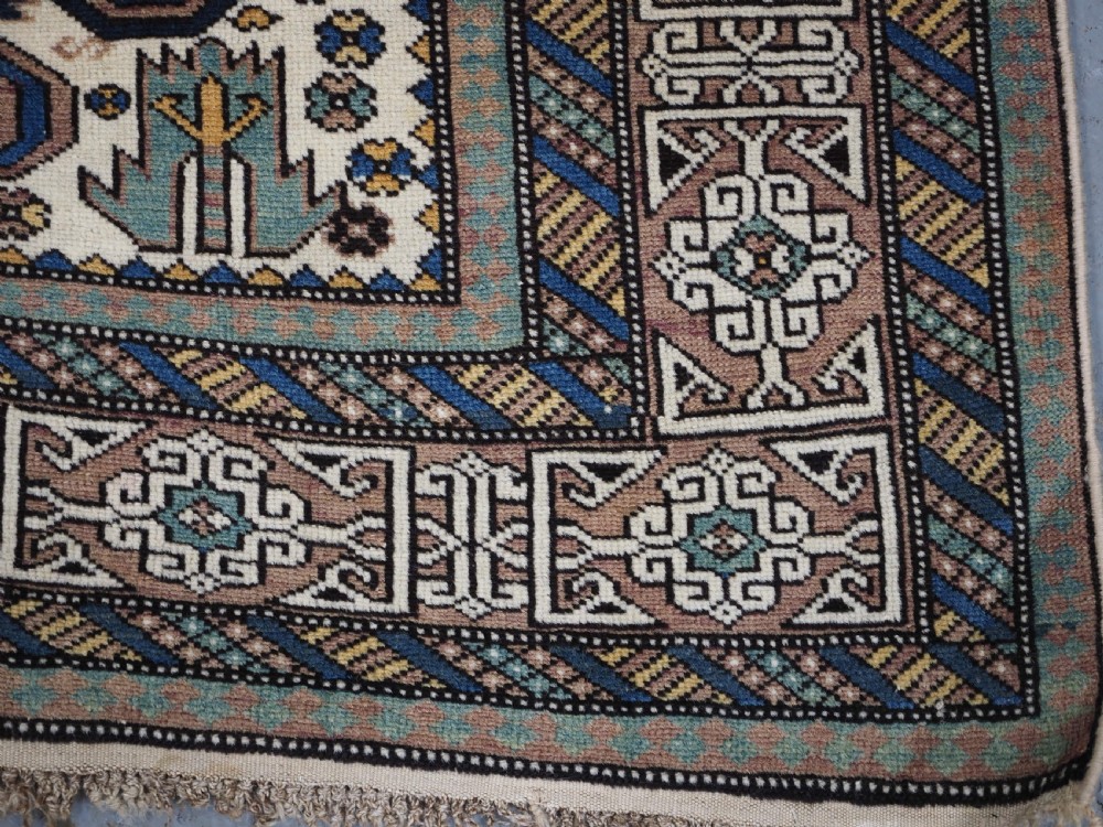 ANTIQUE CAUCASIAN KUBA REGION WHITE GROUND PEREPEDIL RUG, CIRCA 1890. View X