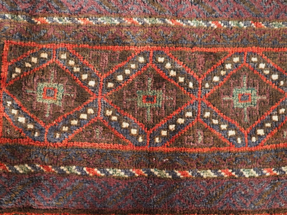 ANTIQUE AFGHAN TRIBAL STORAGE BAG COMPLETE WITH TASSELS, CIRCA 1920. View IV