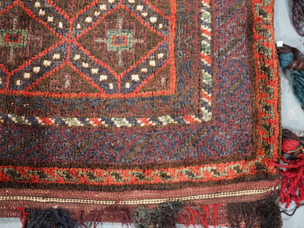 ANTIQUE AFGHAN TRIBAL STORAGE BAG COMPLETE WITH TASSELS, CIRCA 1920. View V