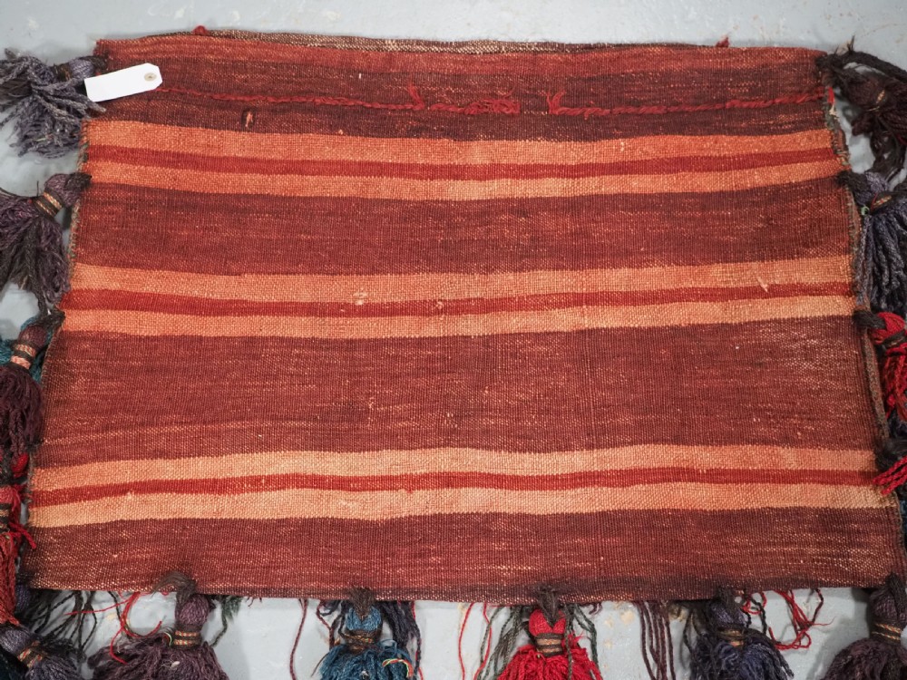ANTIQUE AFGHAN TRIBAL STORAGE BAG COMPLETE WITH TASSELS, CIRCA 1920. View VII