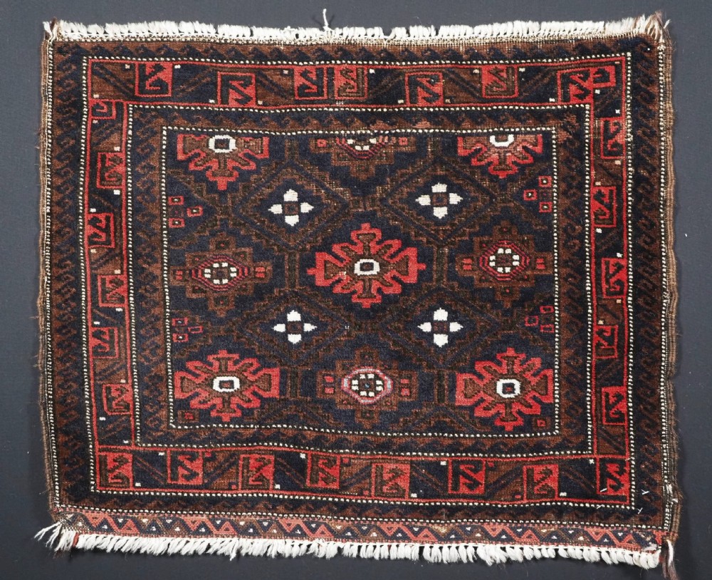 ANTIQUE BALUCH SADDLE BAG FACE WITH SNOWFLAKE DESIGN, CIRCA 1900.