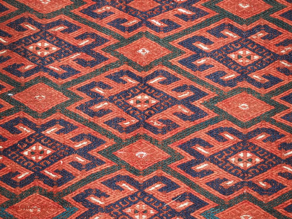 A large rectangular deep red wool flatweave carpet featuring an all-over diamond lattice pattern with detailed geometric borders and palas ends. View XIII