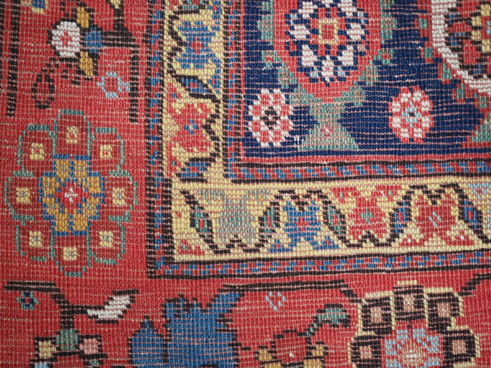 An antique Caucasian Karabagh hand-knotted wool runner rug featuring repeating multi-coloured boteh patterns on a dark navy field surrounded by a red floral border. View XIII
