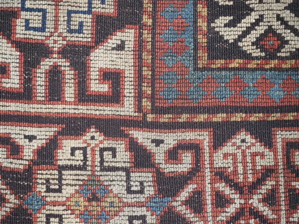 An antique South Caucasian hand-knotted wool rug with a vibrant yellow central field, diamond medallions, and ornate multi-coloured geometric borders. View XIII