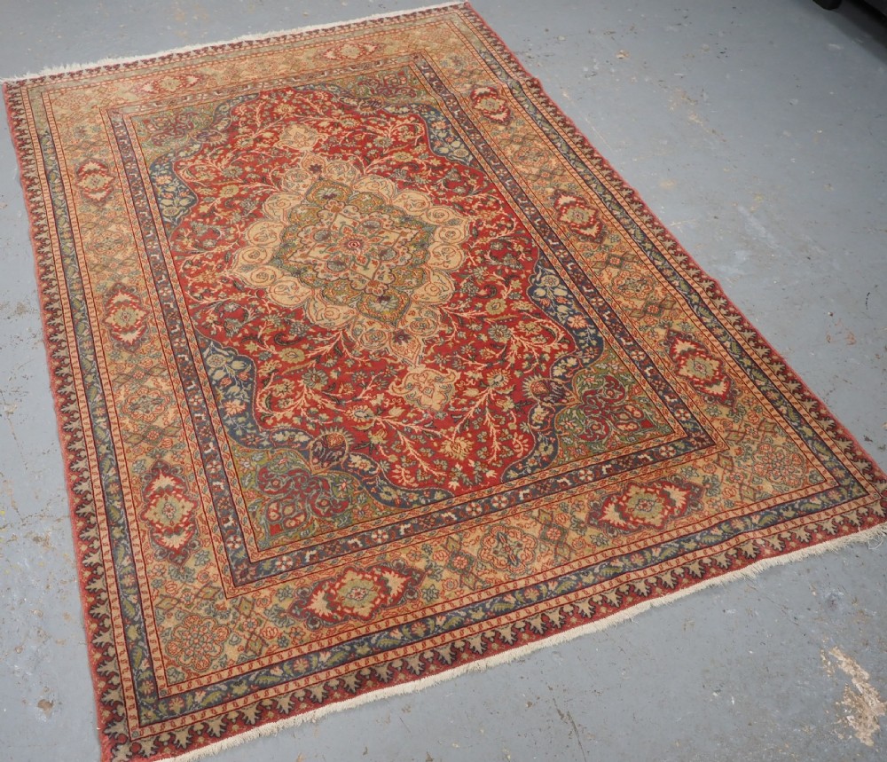An antique Anatolian Sivas hand-knotted wool rug featuring a central cream medallion surrounded by a red field with floral arabesques and multi-tiered borders. View II