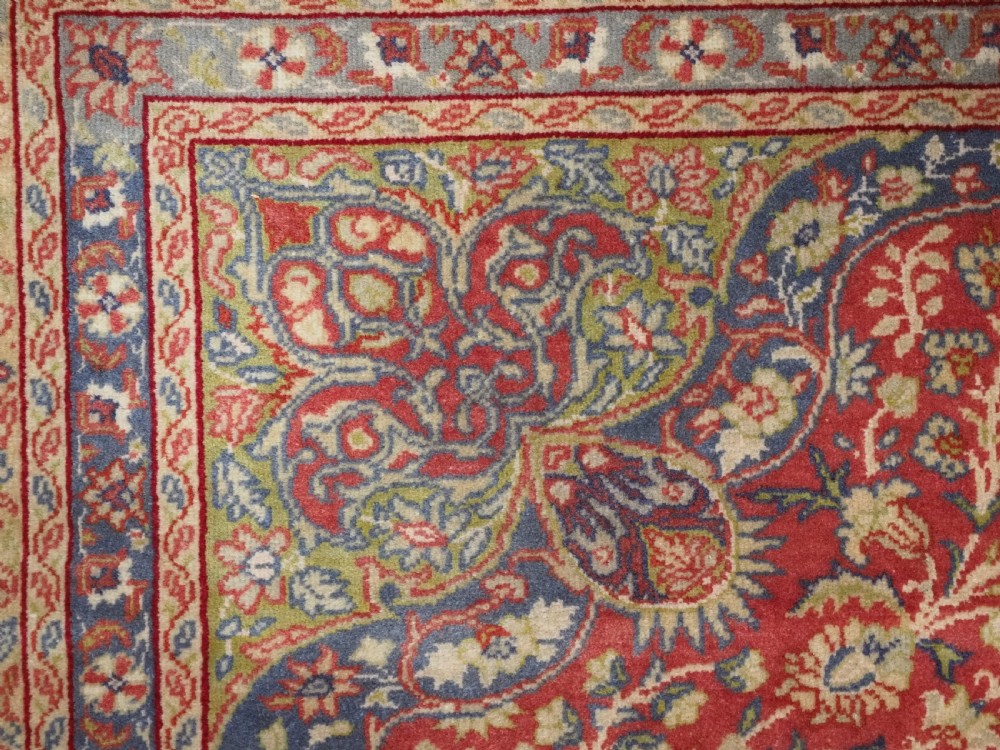 An antique Anatolian Sivas hand-knotted wool rug featuring a central cream medallion surrounded by a red field with floral arabesques and multi-tiered borders. View VIII