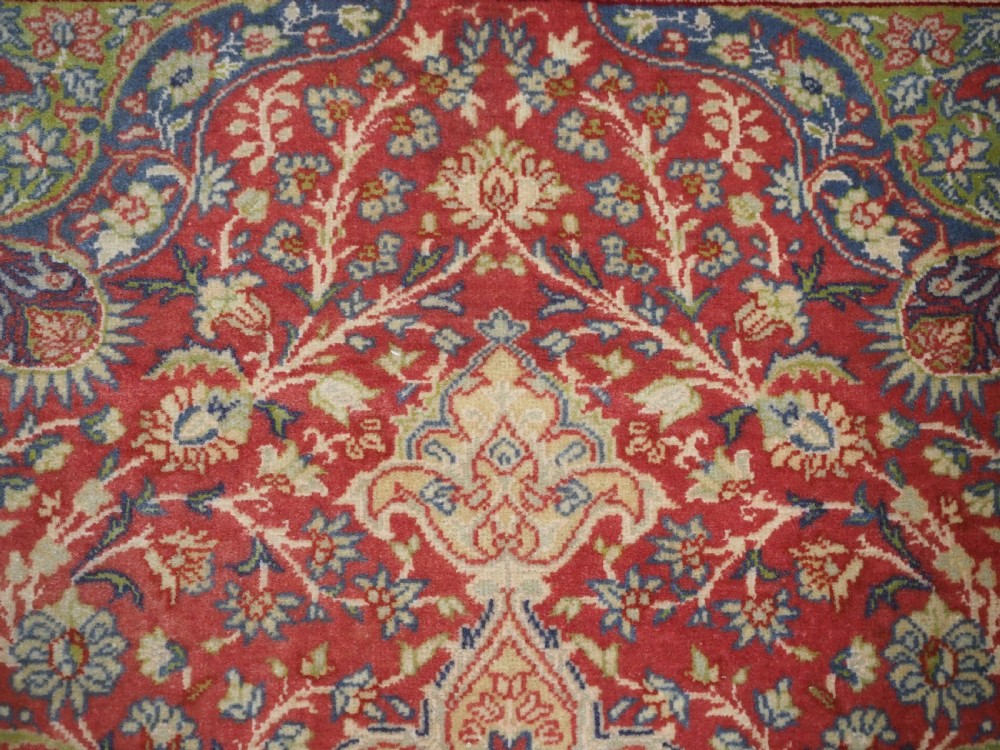 An antique Anatolian Sivas hand-knotted wool rug featuring a central cream medallion surrounded by a red field with floral arabesques and multi-tiered borders. View IX