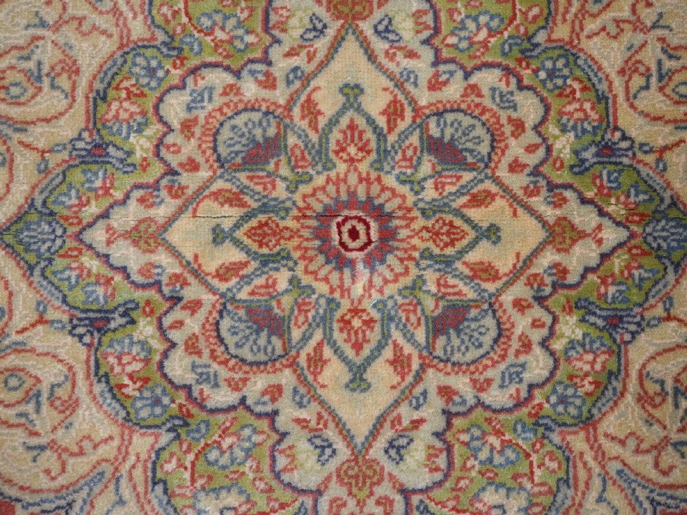 An antique Anatolian Sivas hand-knotted wool rug featuring a central cream medallion surrounded by a red field with floral arabesques and multi-tiered borders. View XI