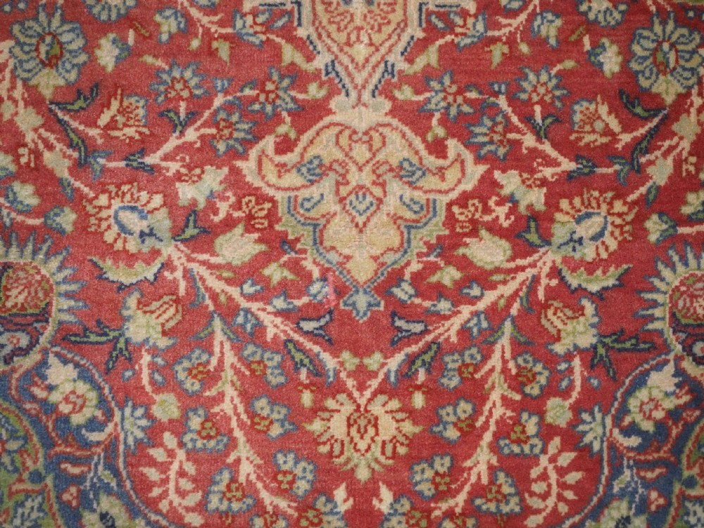 An antique Anatolian Sivas hand-knotted wool rug featuring a central cream medallion surrounded by a red field with floral arabesques and multi-tiered borders. View XII