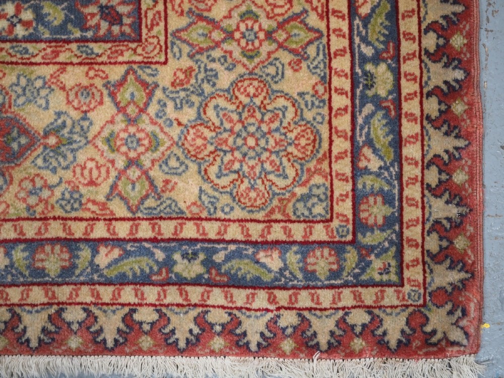 An antique Anatolian Sivas hand-knotted wool rug featuring a central cream medallion surrounded by a red field with floral arabesques and multi-tiered borders. View XIV