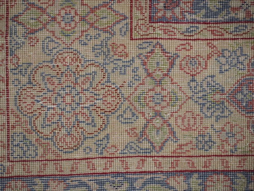 An antique Anatolian Sivas hand-knotted wool rug featuring a central cream medallion surrounded by a red field with floral arabesques and multi-tiered borders. View XV