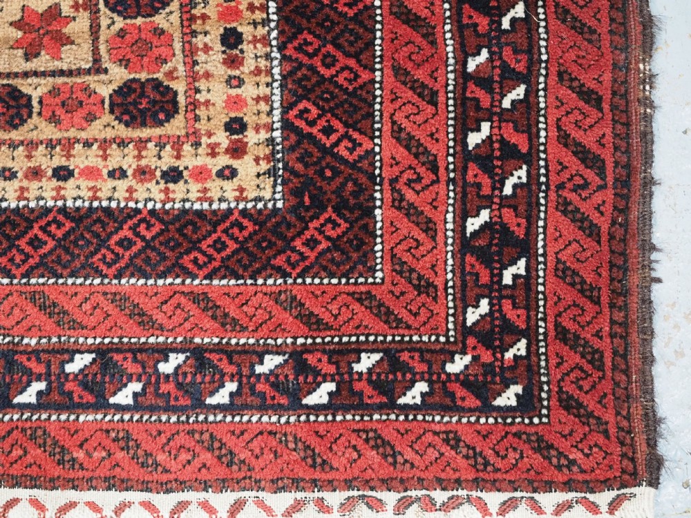 An antique Baluch wool prayer rug featuring a central mihrab arch, tree motifs, hand icons, and geometric borders in dark red, brown, and camel shades. View XIV