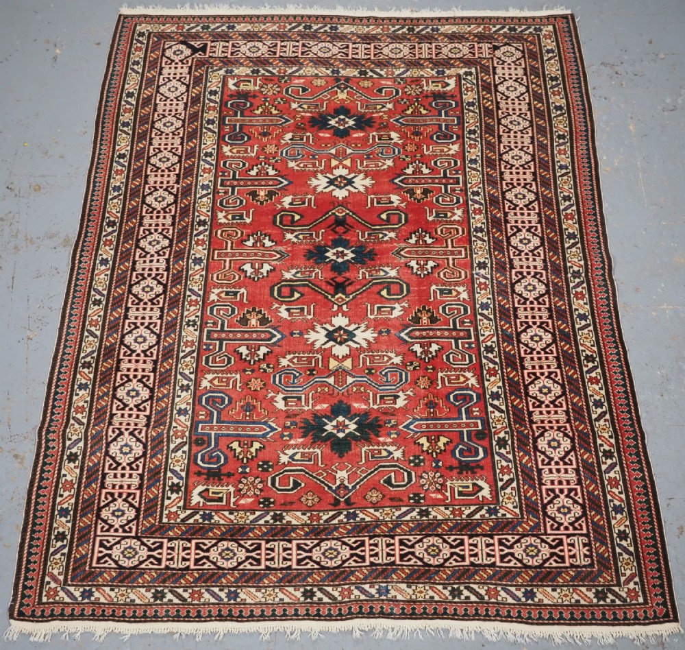 ANTIQUE CAUCASIAN KUBA PEREPEDIL RUG WITH SOFT RED GROUND, CIRCA 1900.