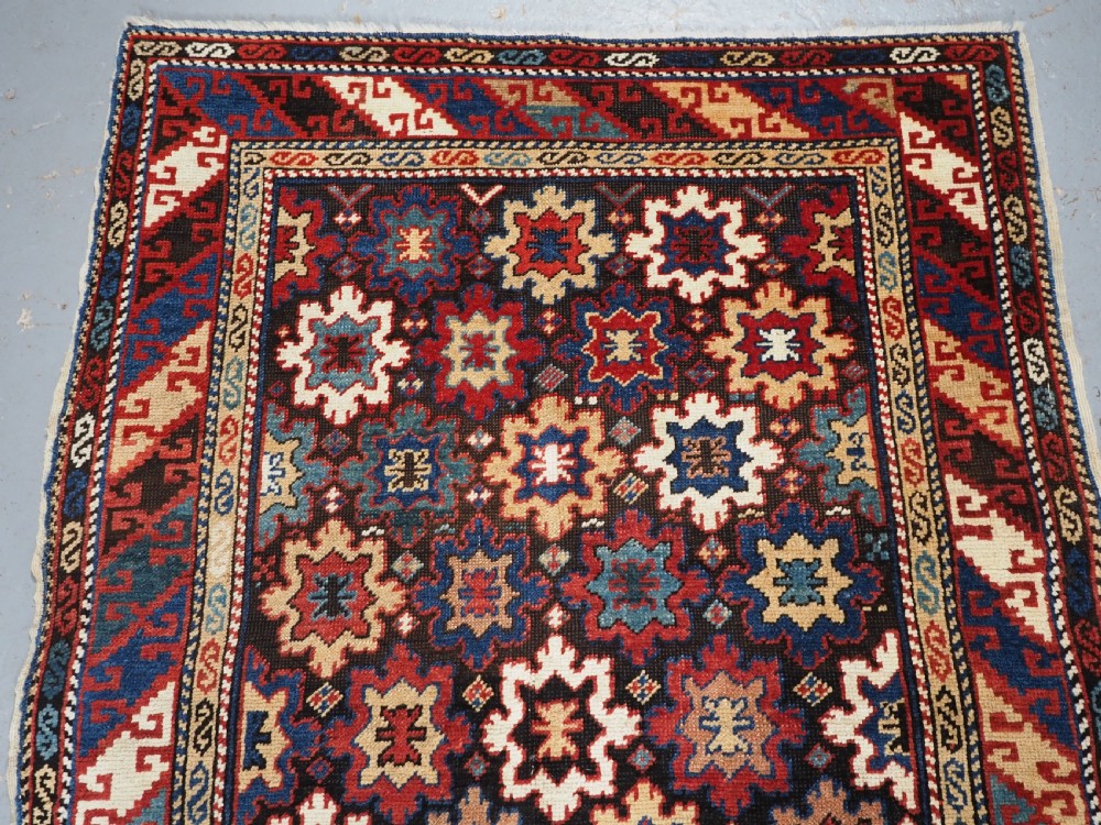 ANTIQUE CAUCASIAN DAGESTAN RUG WITH BLOSSOM DESIGN, CIRCA 1880. View III