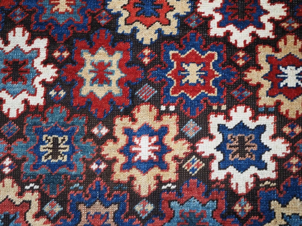 ANTIQUE CAUCASIAN DAGESTAN RUG WITH BLOSSOM DESIGN, CIRCA 1880. View VIII