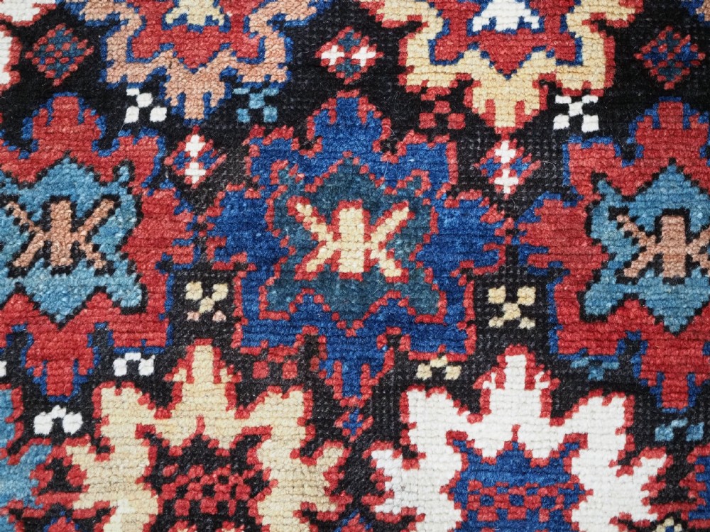 ANTIQUE CAUCASIAN DAGESTAN RUG WITH BLOSSOM DESIGN, CIRCA 1880. View IX